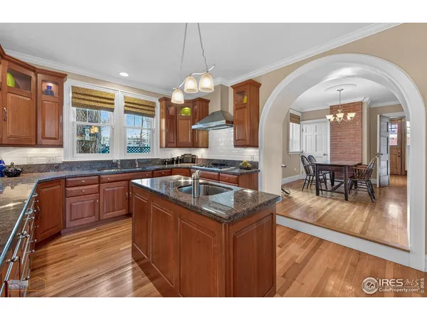a kitchen with granite countertop a sink counter space cabinets and stainless steel appliances