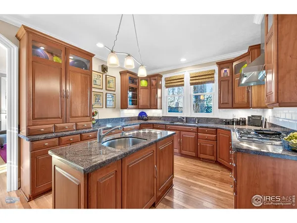 a kitchen with stainless steel appliances granite countertop a stove and a wooden cabinets