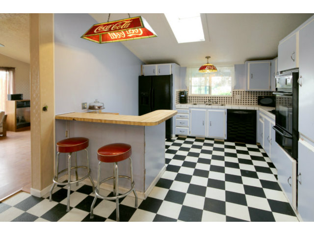 561 Lakeview Road Watsonville, CA 95076 - Photo 3 of 21 a kitchen with stainless steel appliances kitchen island a rug stove and a window