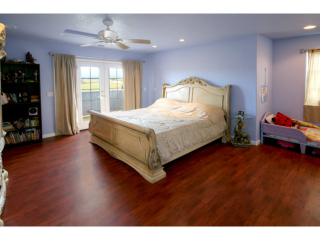 561 Lakeview Road Watsonville, CA 95076 - Photo 6 of 21 a spacious bedroom with a bed and wooden floor