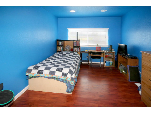 561 Lakeview Road Watsonville, CA 95076 - Photo 8 of 21 a bedroom with a bed and a flat screen tv