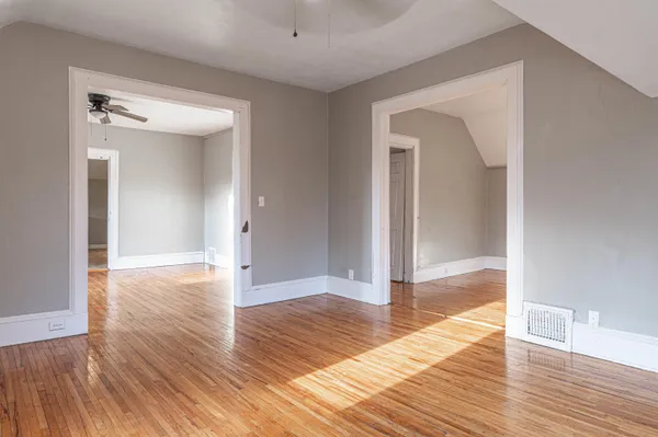 a view of a hallway view with wooden floor and staircase