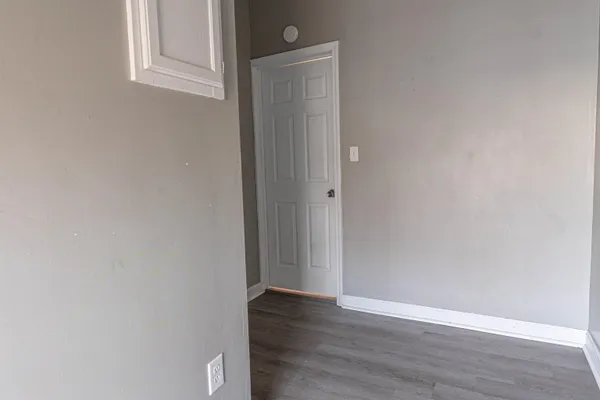 a view of a small space with wooden floor and closet