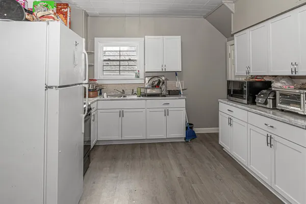 a kitchen with a sink appliances and cabinets