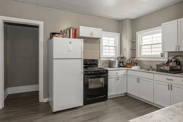 a white refrigerator freezer sitting inside of a kitchen