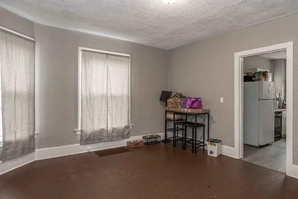 an empty room with floor to ceiling window and closet
