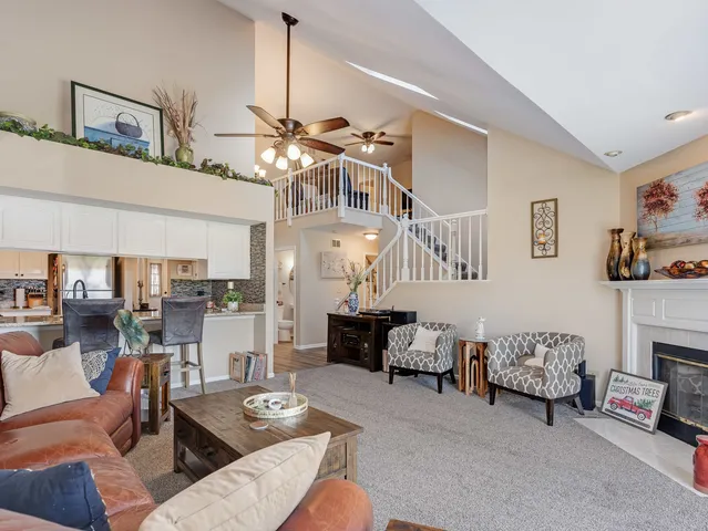 a living room with furniture and a chandelier