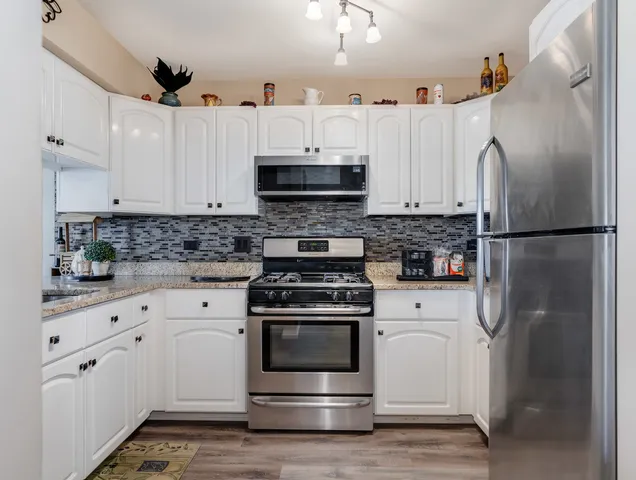 a kitchen with cabinets appliances and a sink