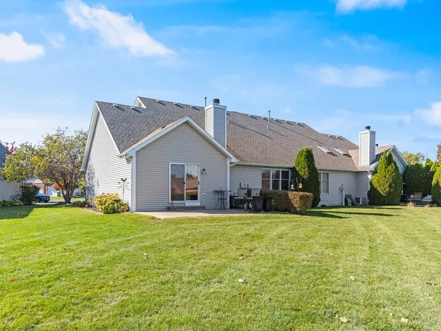 a view of a house with a yard and garage