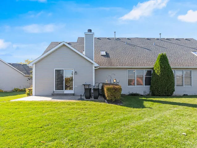 a front view of house with yard and outdoor seating