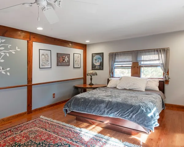 a bedroom with a large bed and a window