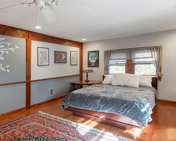 a bedroom with a large bed and a window