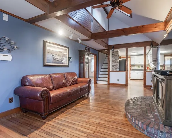 a view of a livingroom with furniture and a ceiling fan