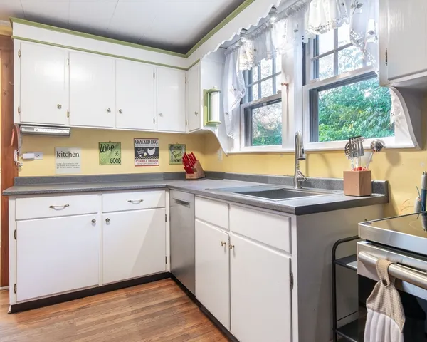 a kitchen with a sink cabinets and window