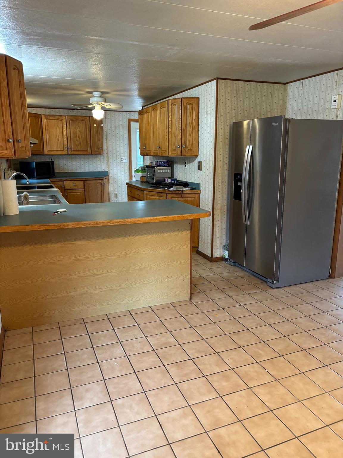 1072 Calvert Road Rising Sun, MD 21911 - Photo 11 of 17 a kitchen with stainless steel appliances a refrigerator sink and cabinets
