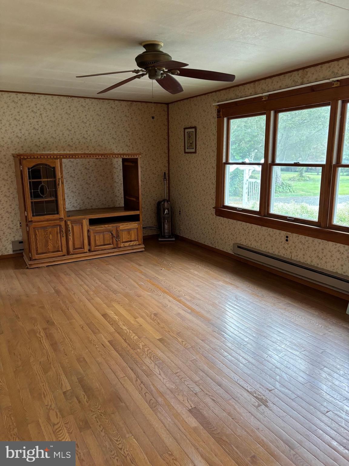 1072 Calvert Road Rising Sun, MD 21911 - Photo 12 of 17 a view of an empty room with window and wooden floor
