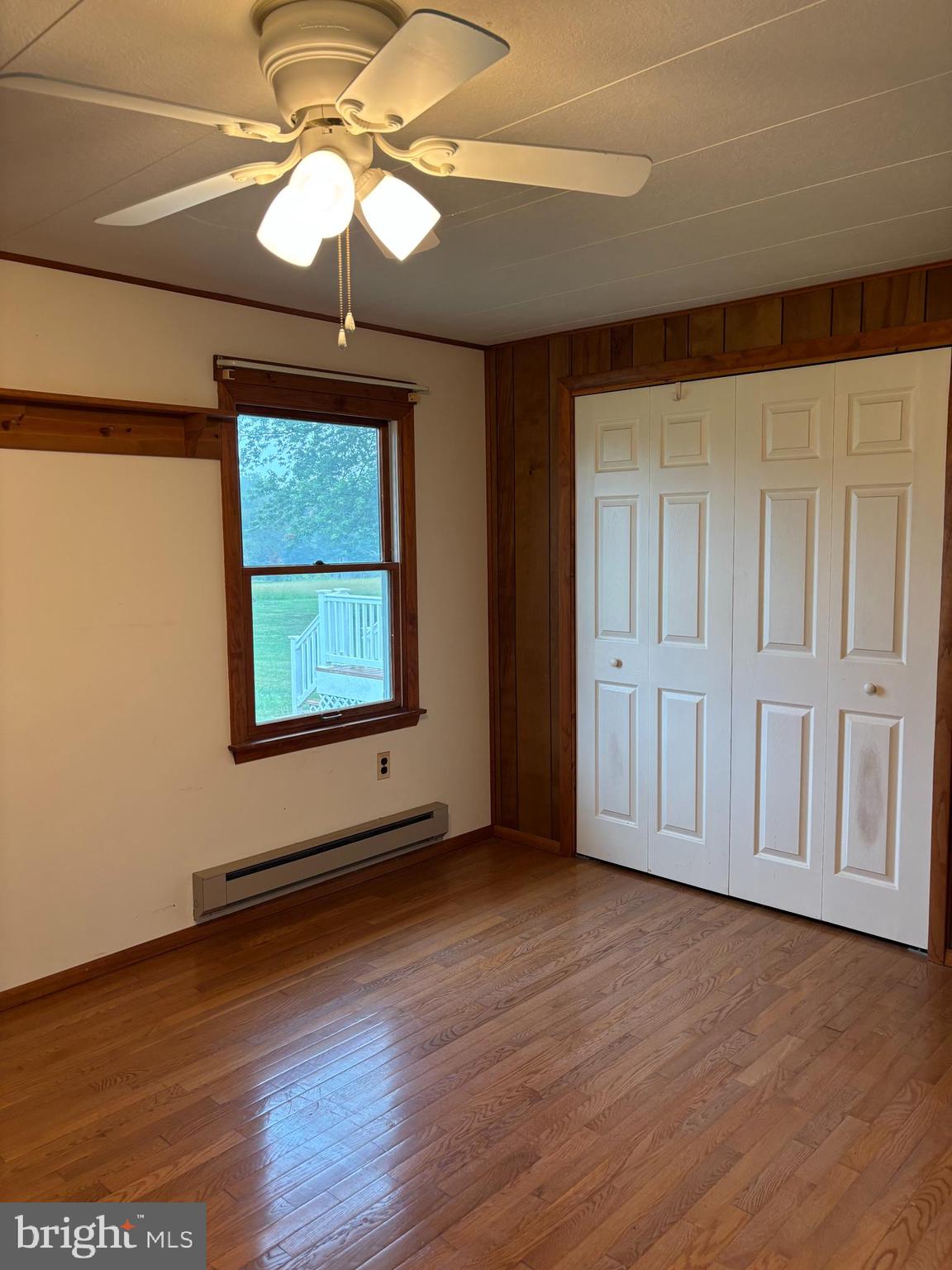1072 Calvert Road Rising Sun, MD 21911 - Photo 13 of 17 an empty room with wooden floor chandelier and windows