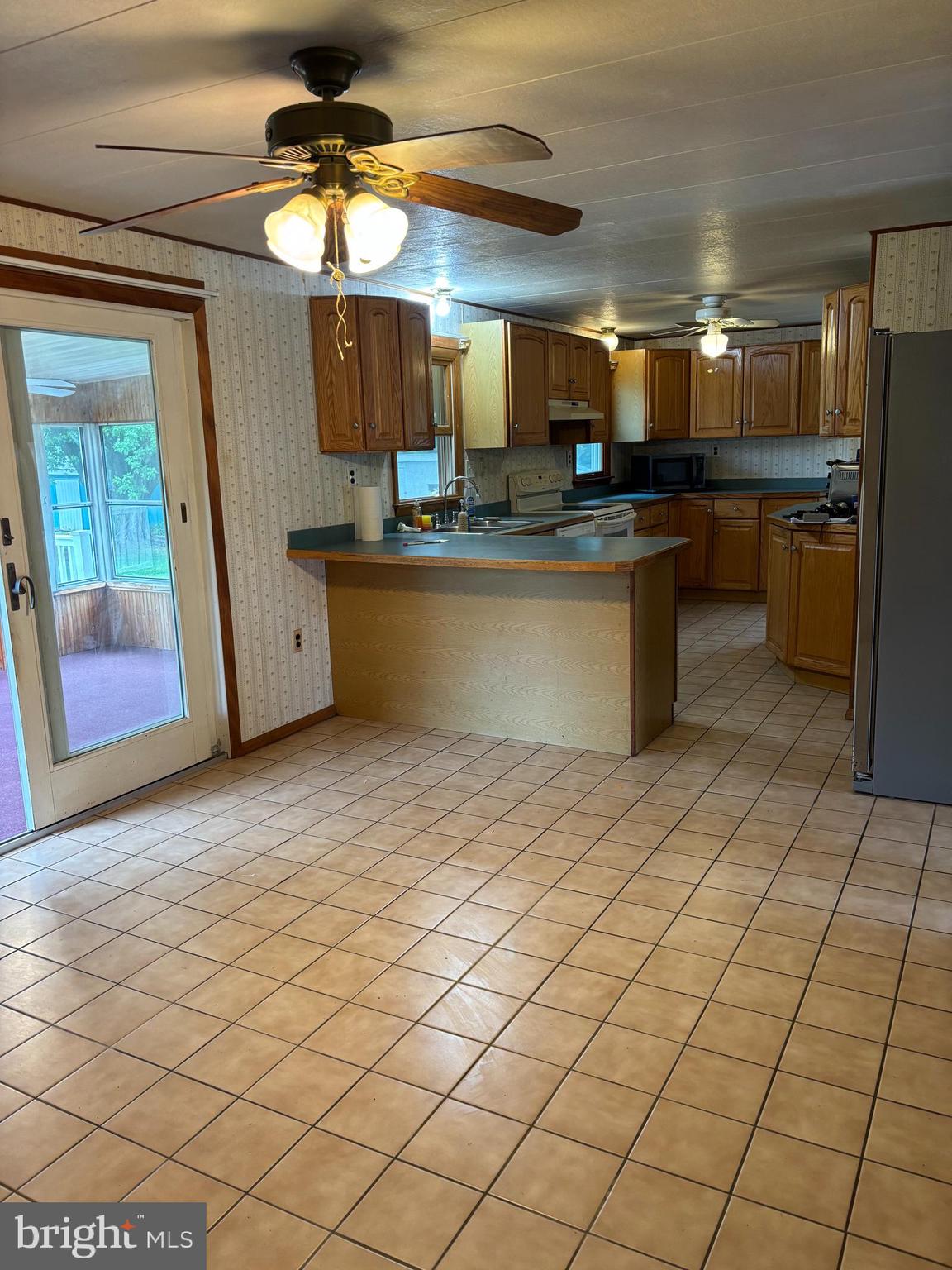 1072 Calvert Road Rising Sun, MD 21911 - Photo 10 of 17 a kitchen with stainless steel appliances granite countertop a sink and a refrigerator