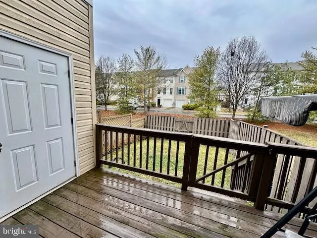 a view of balcony with wooden floor and fence