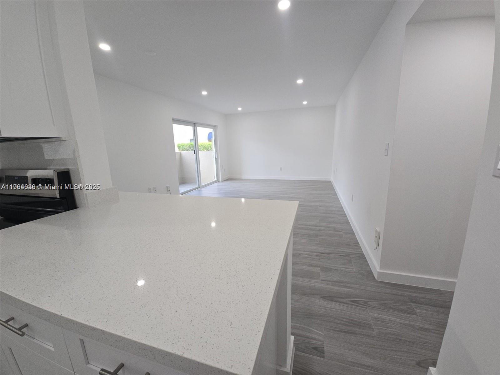 7707 Southwest 86th Street, Unit B101 Miami, FL 33143 - Photo 3 of 12 a view of empty room with wooden floor