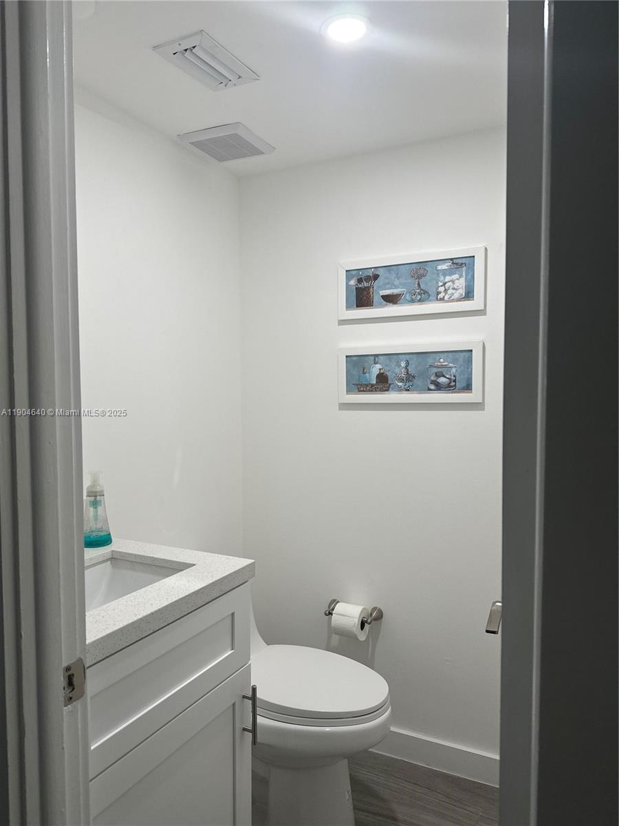 7707 Southwest 86th Street, Unit B101 Miami, FL 33143 - Photo 7 of 12 a bathroom with a toilet and a sink