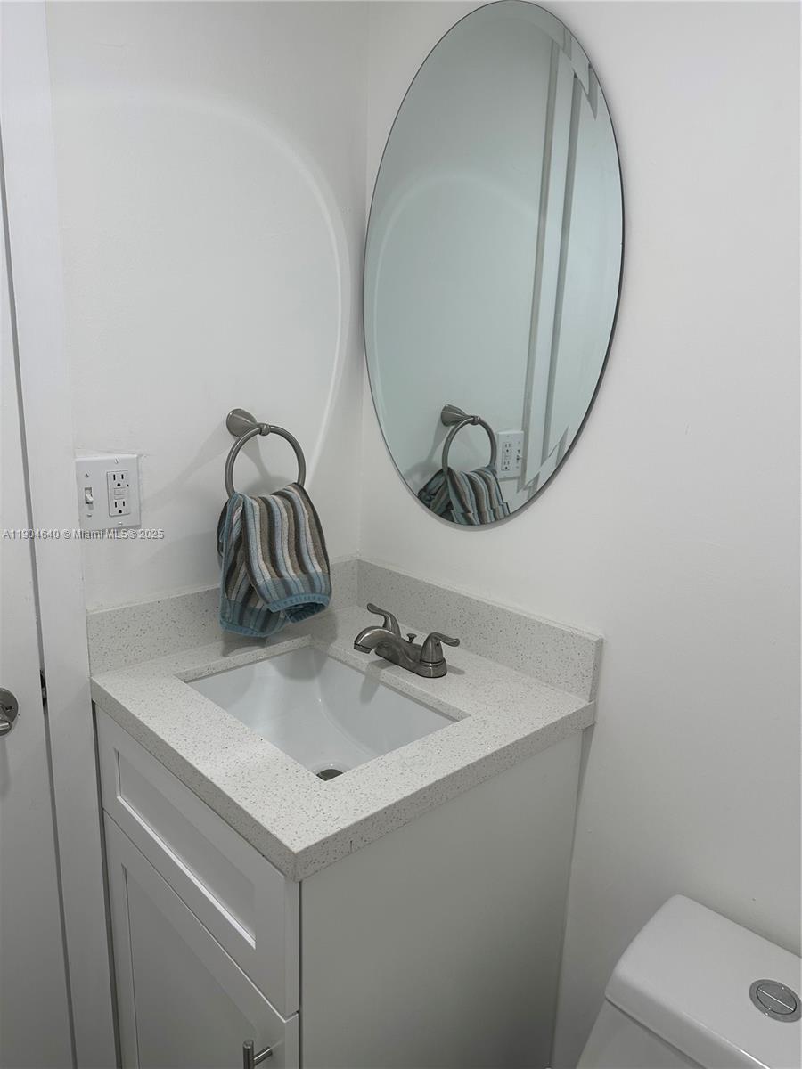 7707 Southwest 86th Street, Unit B101 Miami, FL 33143 - Photo 8 of 12 a bathroom with a sink and a mirror