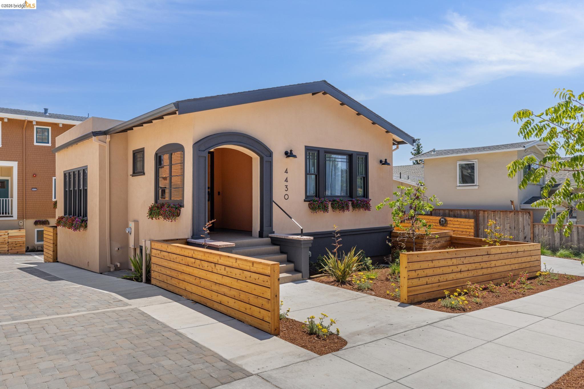 a front view of a house with outdoor seating and a yard