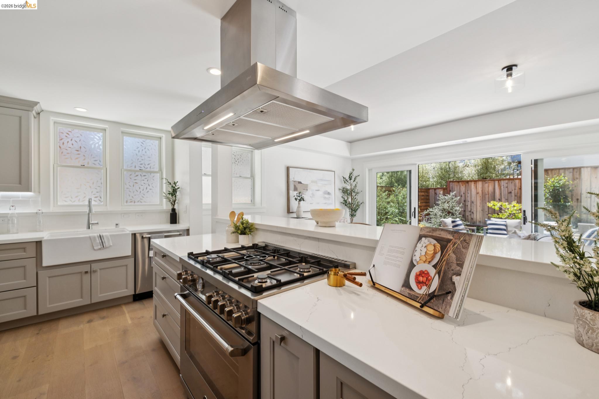 4430 Howe Street Oakland, CA 94611 - Photo 19 of 58 a kitchen with a stove a sink and a granite counter top space