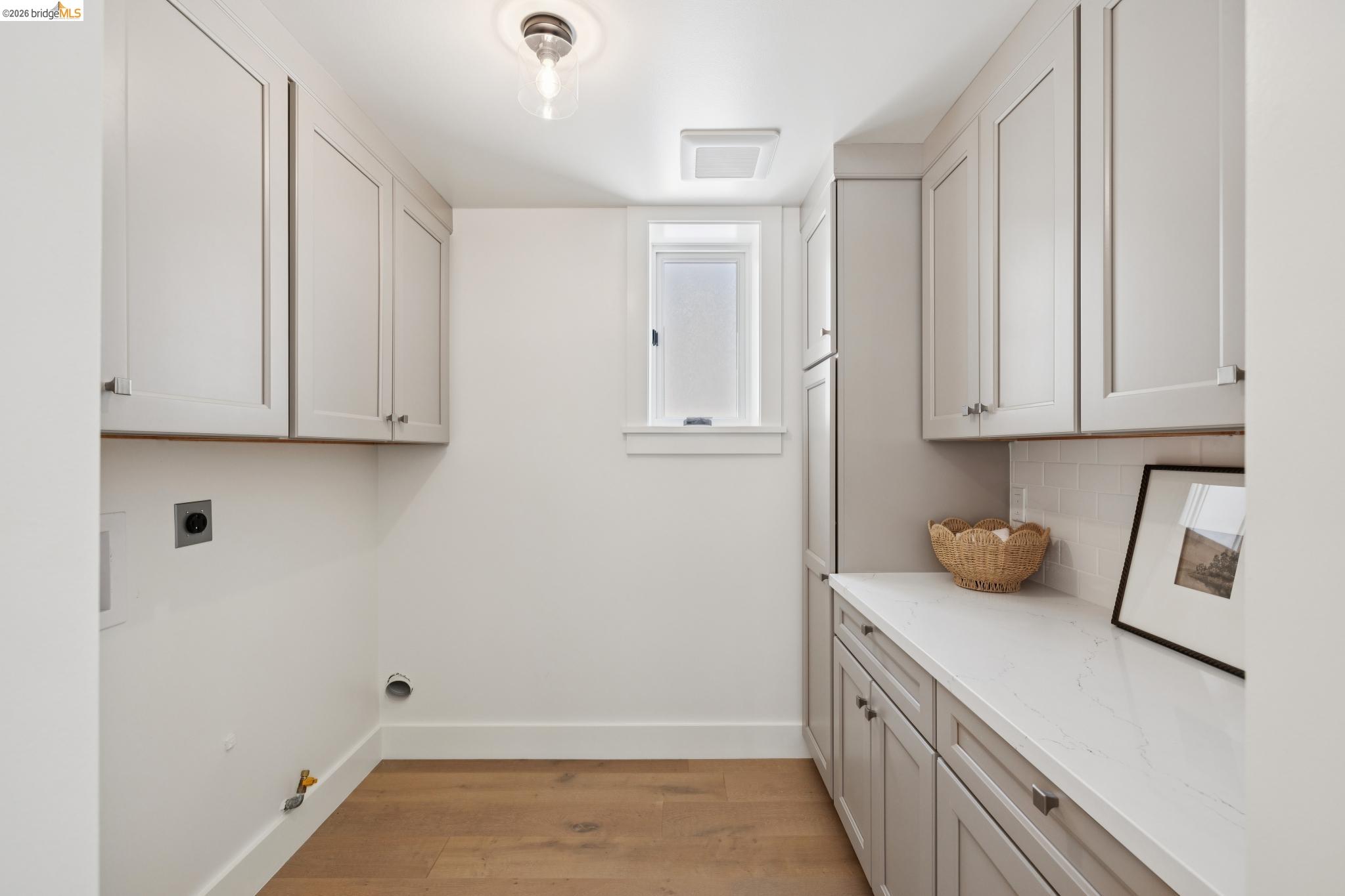 4430 Howe Street Oakland, CA 94611 - Photo 24 of 58 a kitchen with white cabinets and sink