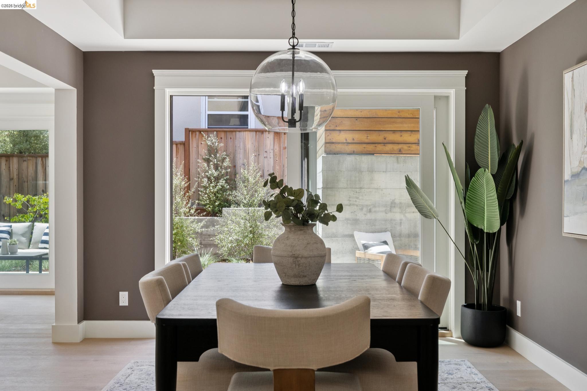 4430 Howe Street Oakland, CA 94611 - Photo 27 of 58 a dining room with furniture a potted plant and a chandelier