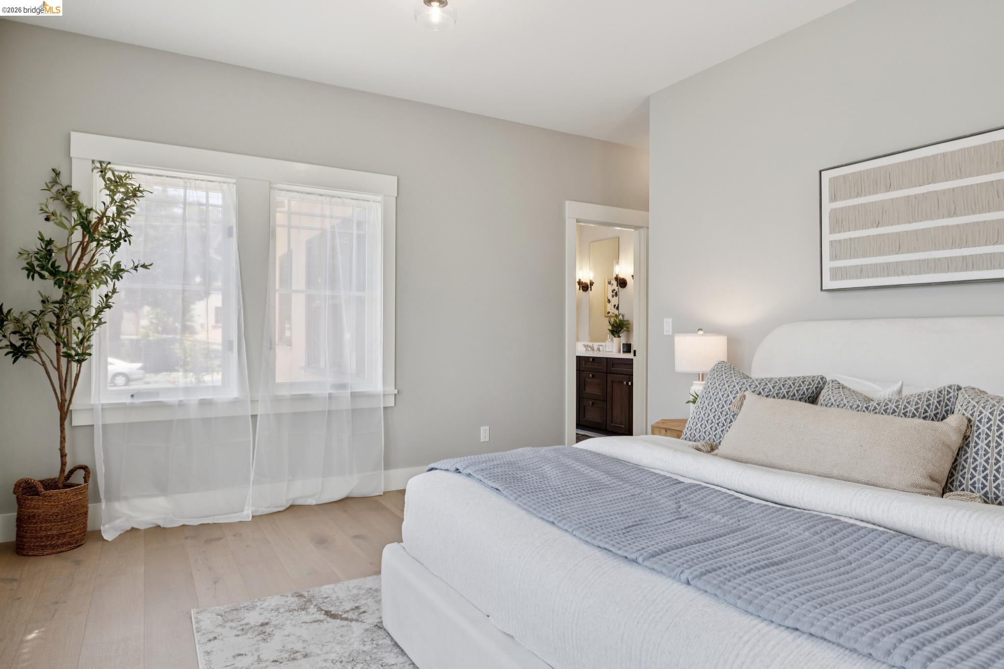 4430 Howe Street Oakland, CA 94611 - Photo 36 of 58 a bedroom with a bed and a potted plant
