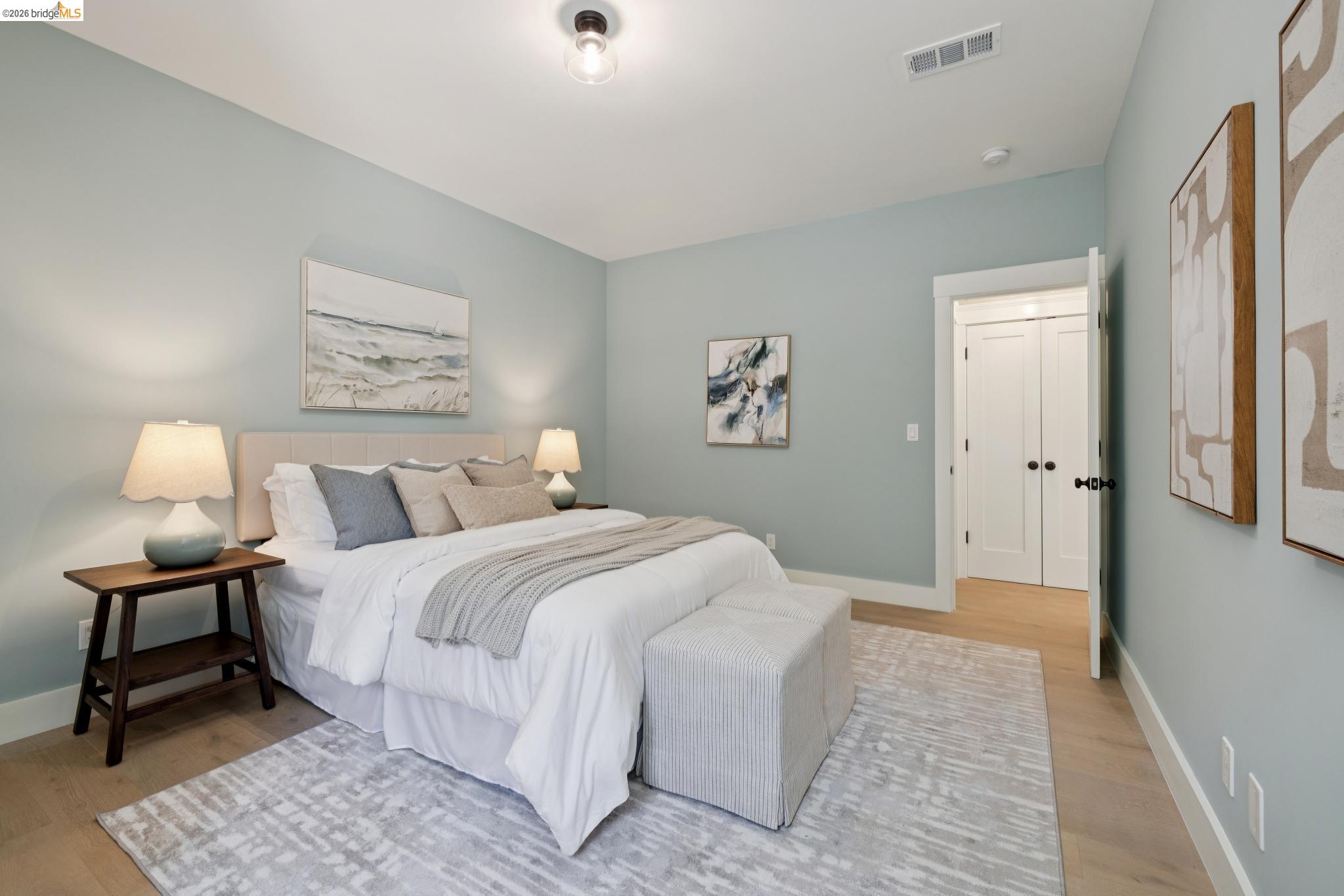 4430 Howe Street Oakland, CA 94611 - Photo 42 of 58 a bedroom with a bed and a lamp