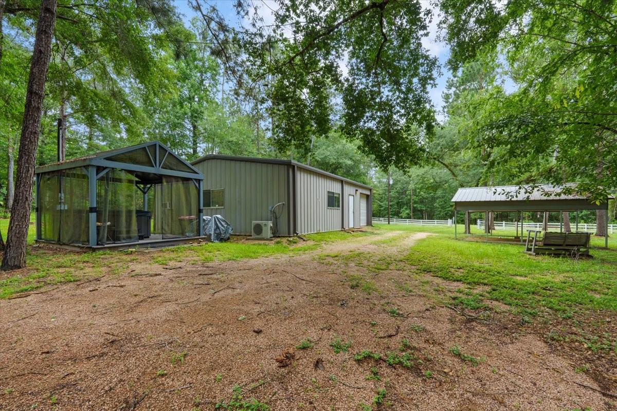 16375 Grand Flower Road Plantersville, TX 77363 - Photo 45 of 50 a view of a house with a yard