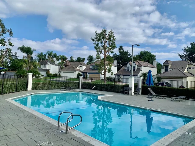a view of swimming pool with outdoor seating and plants