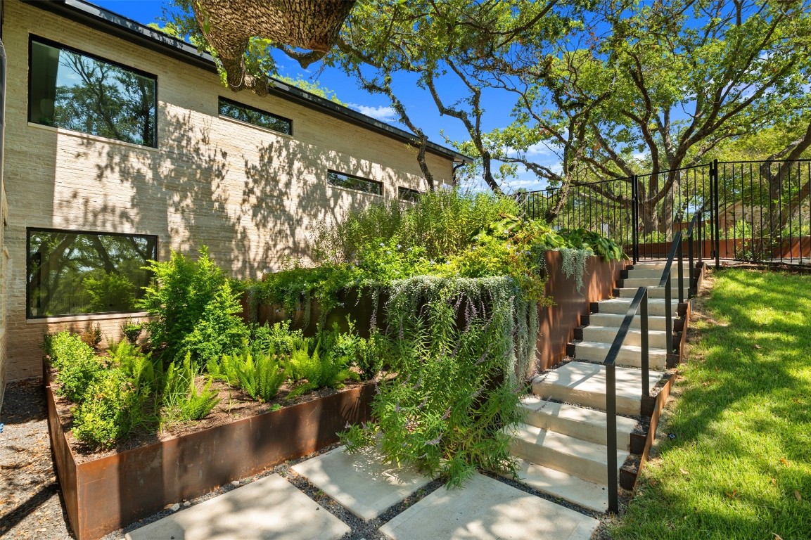 1704 Trevino Drive Austin, TX 78746 - Photo 1 of 1 a backyard of a house with lots of green space