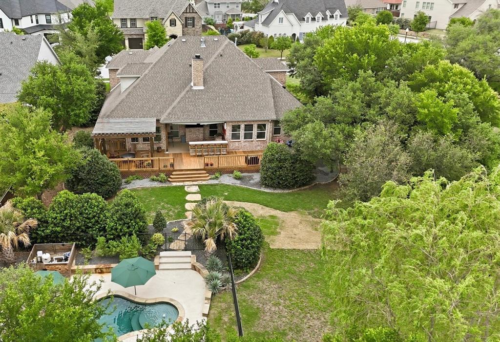 This dreamy back yard boasts .4 acres with multiple custom patios and a dedicated pool area.