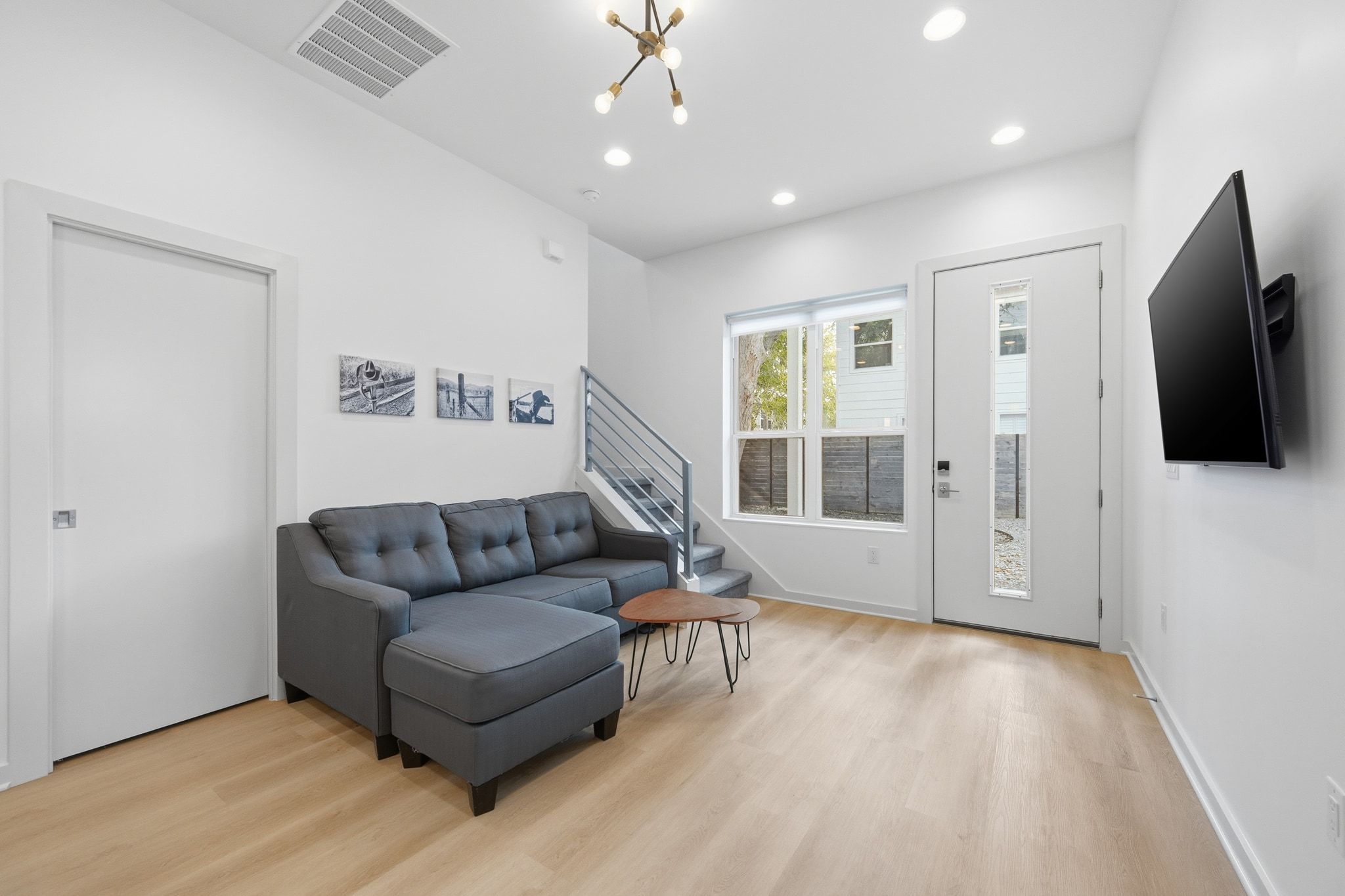 2811 Garwood Street, Unit B Austin, TX 78702 - Photo 7 of 24 Living room with a chandelier, stairs, light wood-style flooring, and recessed lighting