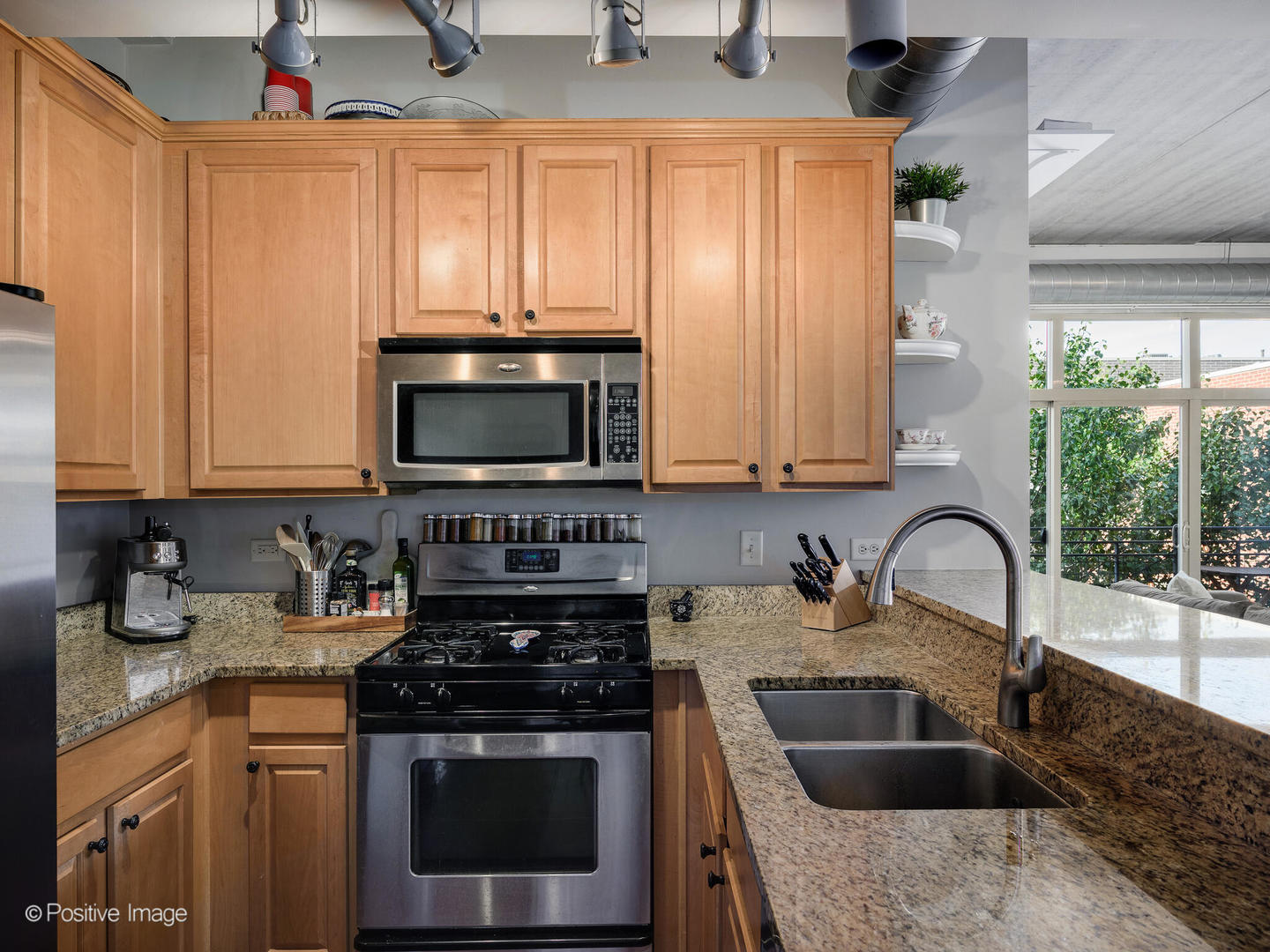 1228 West Monroe Street, Unit 408 Chicago, IL 60607 - Photo 11 of 17 a kitchen with granite countertop a sink stainless steel appliances and cabinets