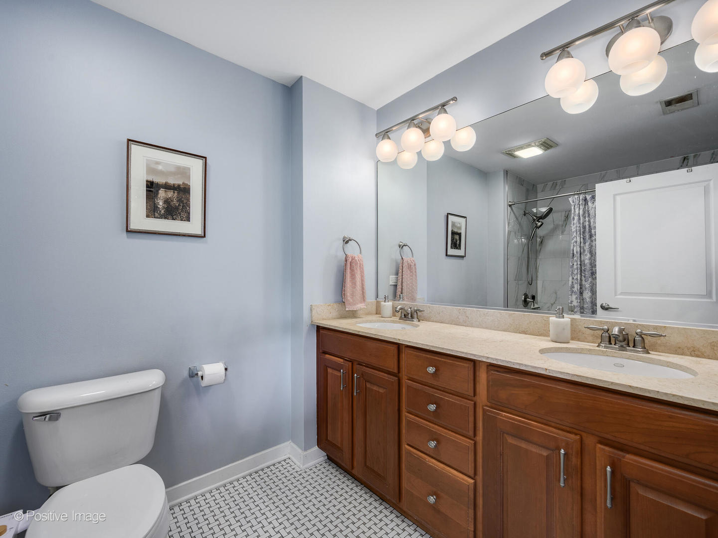 1228 West Monroe Street, Unit 408 Chicago, IL 60607 - Photo 15 of 17 a spacious bathroom with a double vanity sink mirror and toilet