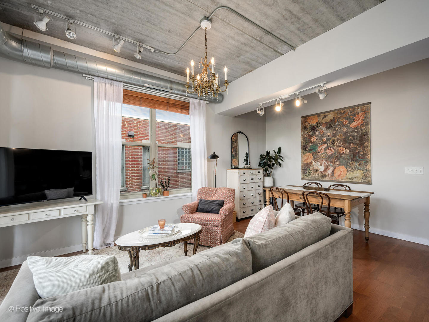 1228 West Monroe Street, Unit 408 Chicago, IL 60607 - Photo 5 of 17 a living room with furniture and a flat screen tv