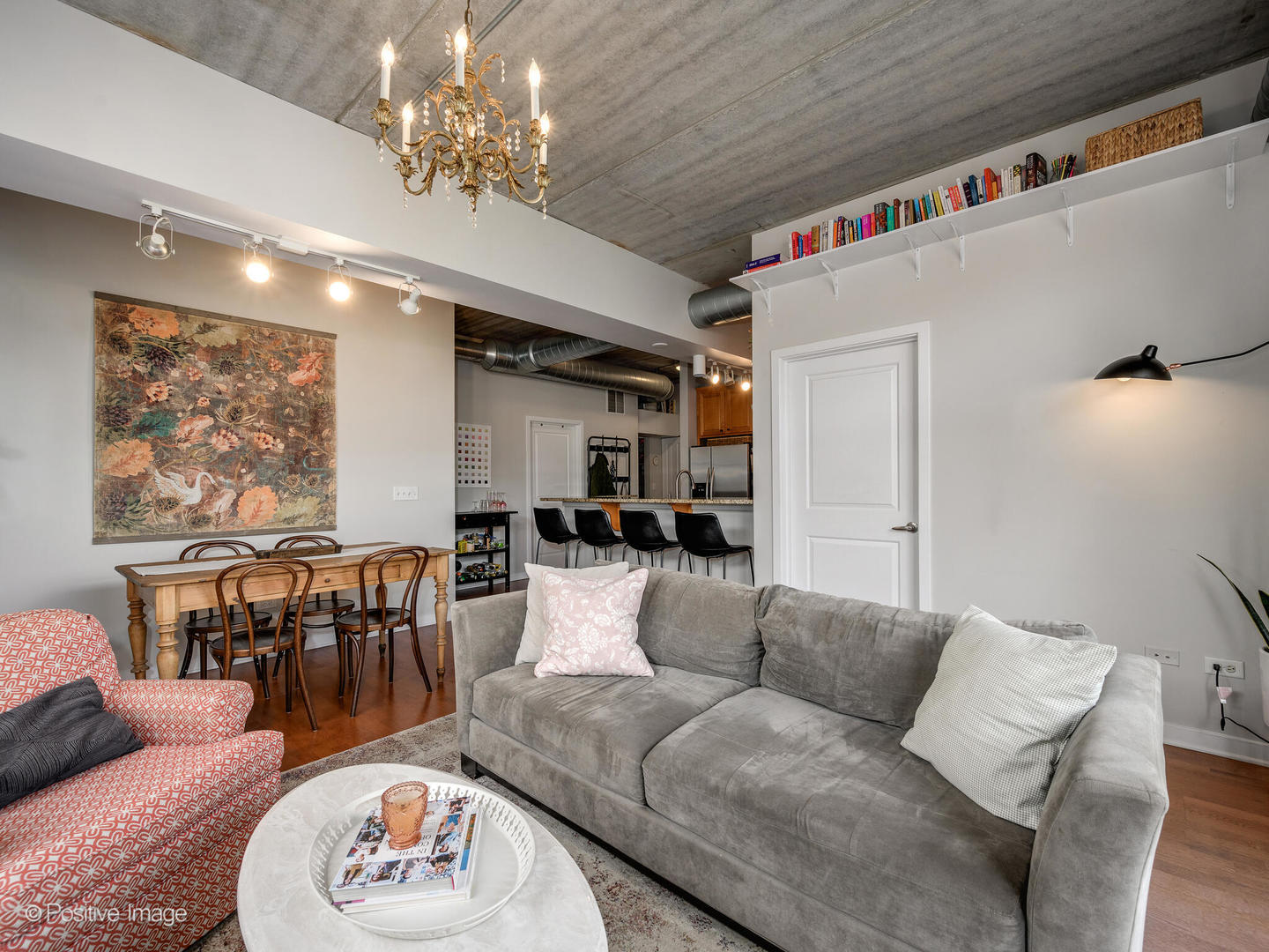 1228 West Monroe Street, Unit 408 Chicago, IL 60607 - Photo 6 of 17 a living room with furniture and a chandelier