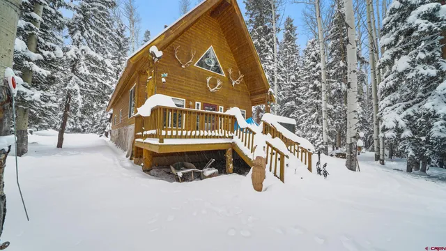 a view of house with a yard covered in snow