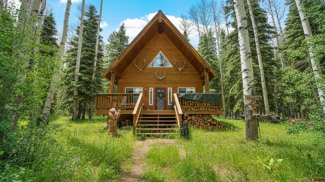 a view of a house with a yard and sitting area