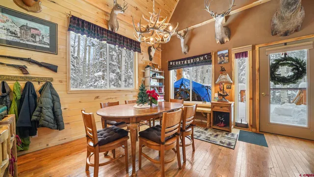 a view of a dining room with furniture and a chandelier