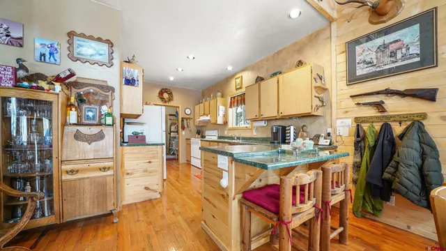 a kitchen with granite countertop stainless steel appliances a sink and cabinets