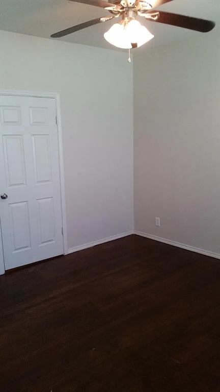 304 Fulton Street, Unit A Denton, TX 76201 - Photo 7 of 17 a view of a room with wooden floor and a window