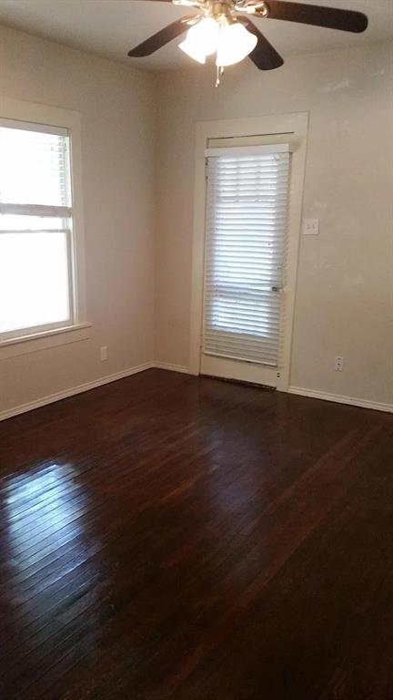304 Fulton Street, Unit A Denton, TX 76201 - Photo 10 of 17 a view of an empty room with wooden floor and a window
