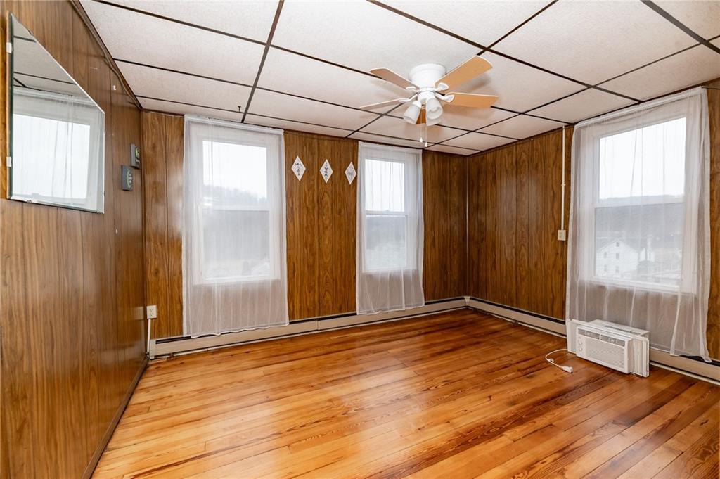 755 Morris Street Clymer, PA 15728 - Photo 11 of 22 an empty room with wooden floor and windows