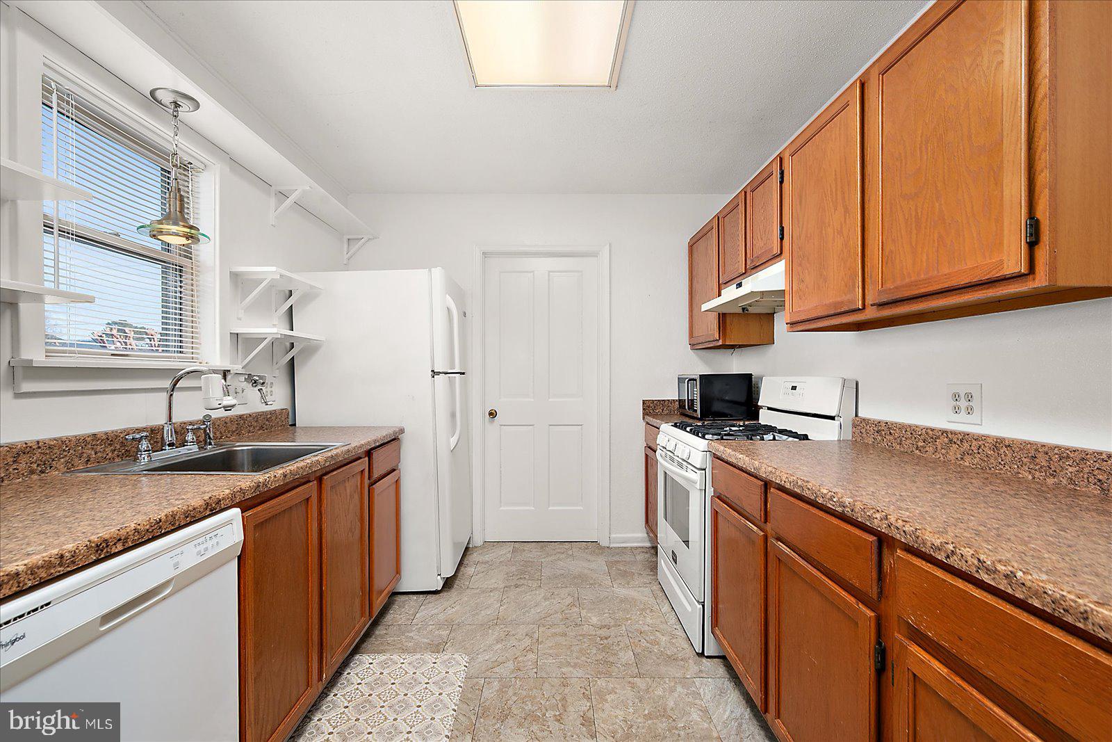10505 Keyser Point Road Ocean City, MD 21842 - Photo 18 of 53 a kitchen with stainless steel appliances granite countertop a sink stove and refrigerator
