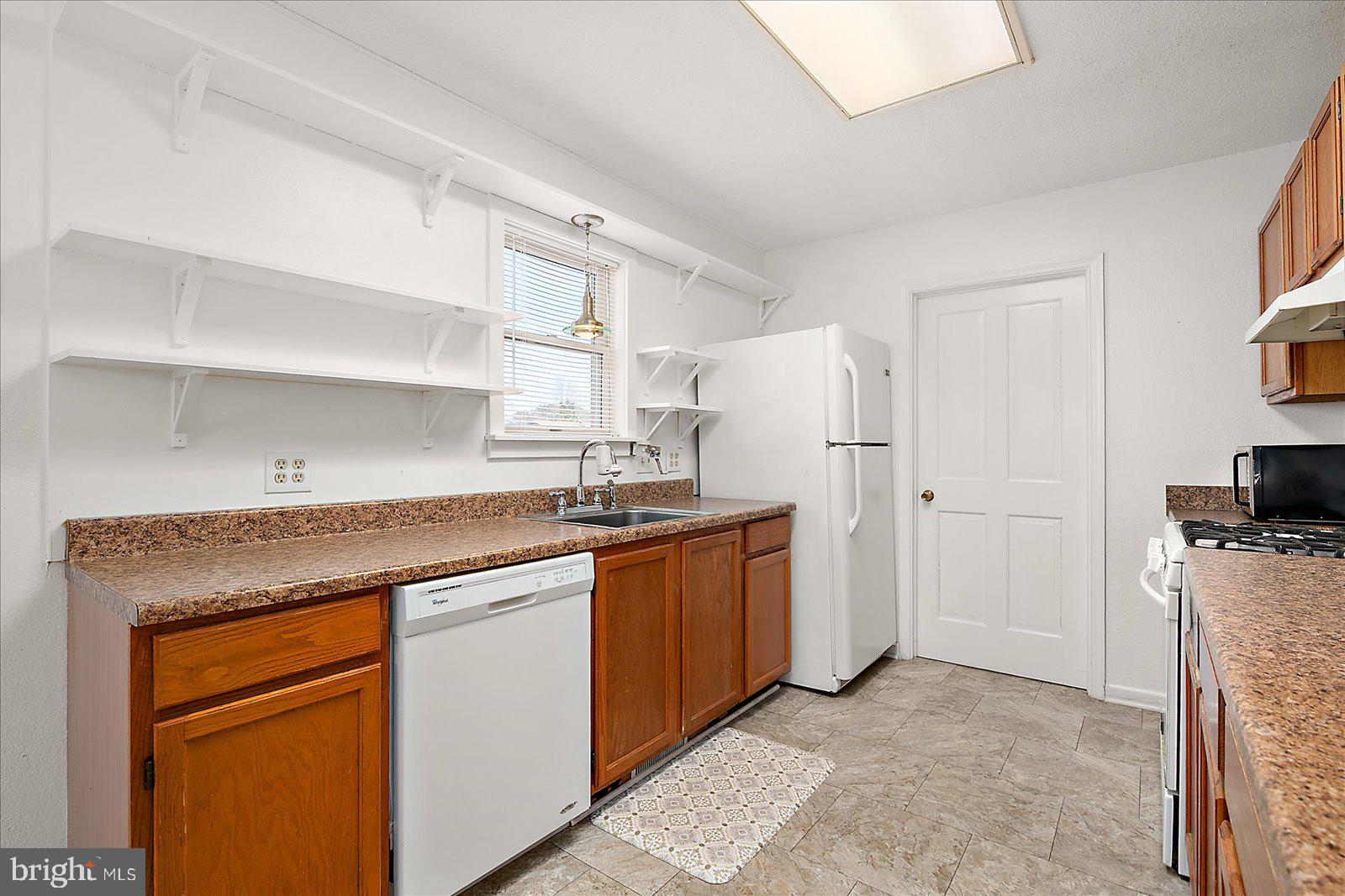 10505 Keyser Point Road Ocean City, MD 21842 - Photo 19 of 53 a kitchen with stainless steel appliances granite countertop a refrigerator and a stove top oven